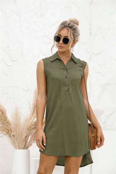 Stylish woman in a high-waisted lapel button slit vest shirt dress, wearing sunglasses and a woven handbag.