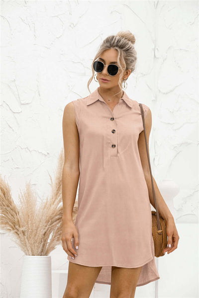 Model wearing a high-waist lapel button slit vest shirt dress in soft pink with stylish sunglasses, paired with a woven bag.