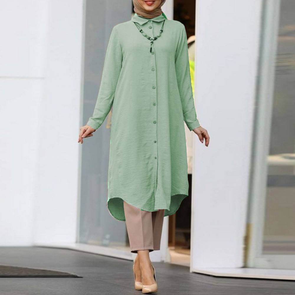 Women's long sleeve button shirt in mint green, featuring a lapel design, paired with neutral-toned trousers for a casual look.