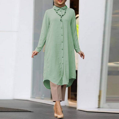Women's long sleeve button shirt in mint green, featuring a lapel design, paired with neutral-toned trousers for a casual look.