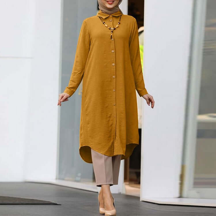Model wearing a mustard women's lapel casual button long sleeve shirt paired with beige pants.